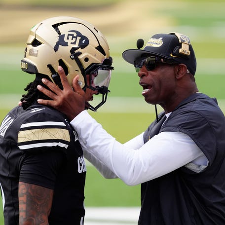 Aug 29, 2025; Boulder, Colorado, USA; Colorado Buffaloes head coach Deion Sanders congratulates Colorado Buffaloes quarterback Kaidon Salter (3) following a touchdown pass in the first quarter against the Georgia Tech Yellow Jackets at Folsom Field. Mandatory Credit: Ron Chenoy-Imagn Images