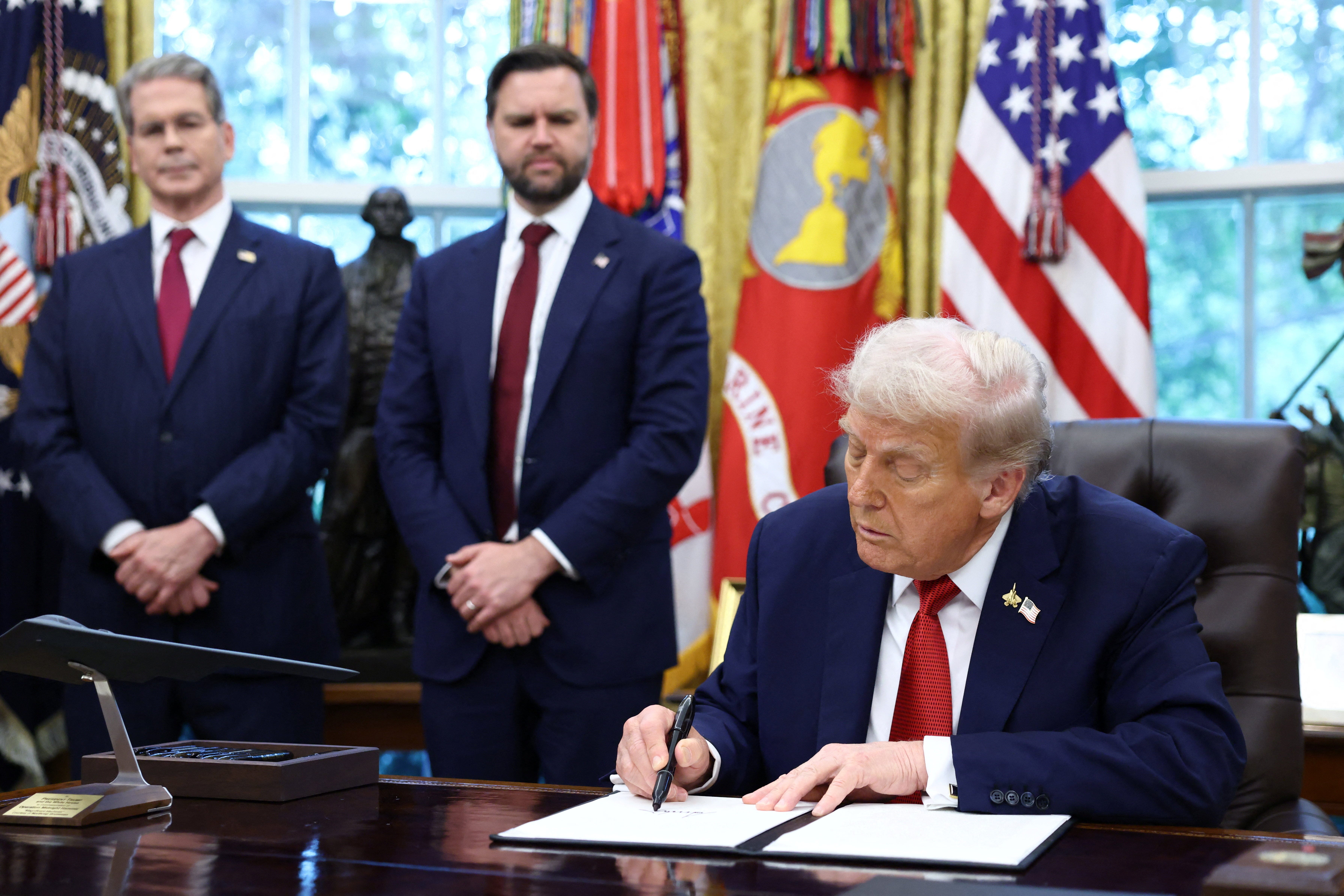 President Donald Trump signs an executive order on a deal that would divest TikTok’s U.S. operations from ByteDance, at the White House in Washington, D.C., September 25, 2025