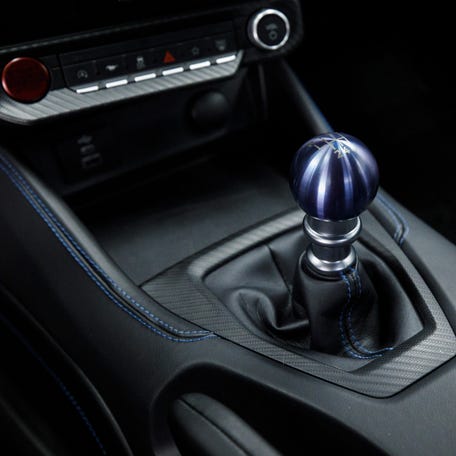 The heart of the Mustang Dark Horse interior is its all-new anodized blue, lightweight titanium manual shift knob.     Preproduction computer-generated images shown.