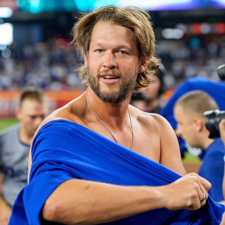 Clayton Kershaw celebrates with teammates after the Dodgers clinched the NL West Division title at Chase Field on Sept. 25, 2025.