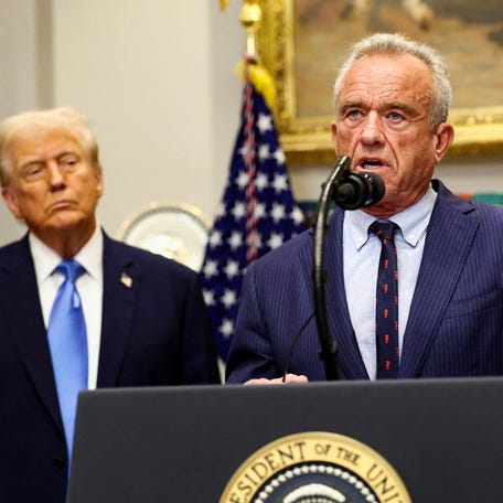 U.S. Secretary of Health and Human Services Robert F. Kennedy Jr. delivers remarks while U.S. President Donald Trump listens during a press conference to announce a link between autism and childhood vaccines and the use of popular pain medication Tylenol for pregnant women and children, claims which are not backed by decades of science, at the White House, in Washington, D.C., U.S., September 22, 2025. REUTERS/Kevin Lamarque