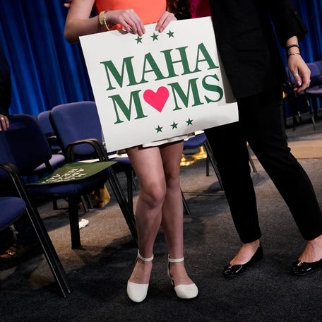 An attendee holds a Make America Healthy Again (MAHA) Moms sign at the end of a press conference announcing of the U.S. Food and Drug Administration's (FDA) intent to phase out the use of petroleum-based synthetic dyes in the nation's food supply, at the Department of Health and Human Services in Washington, D.C., U.S., April 22, 2025. REUTERS/Elizabeth Frantz