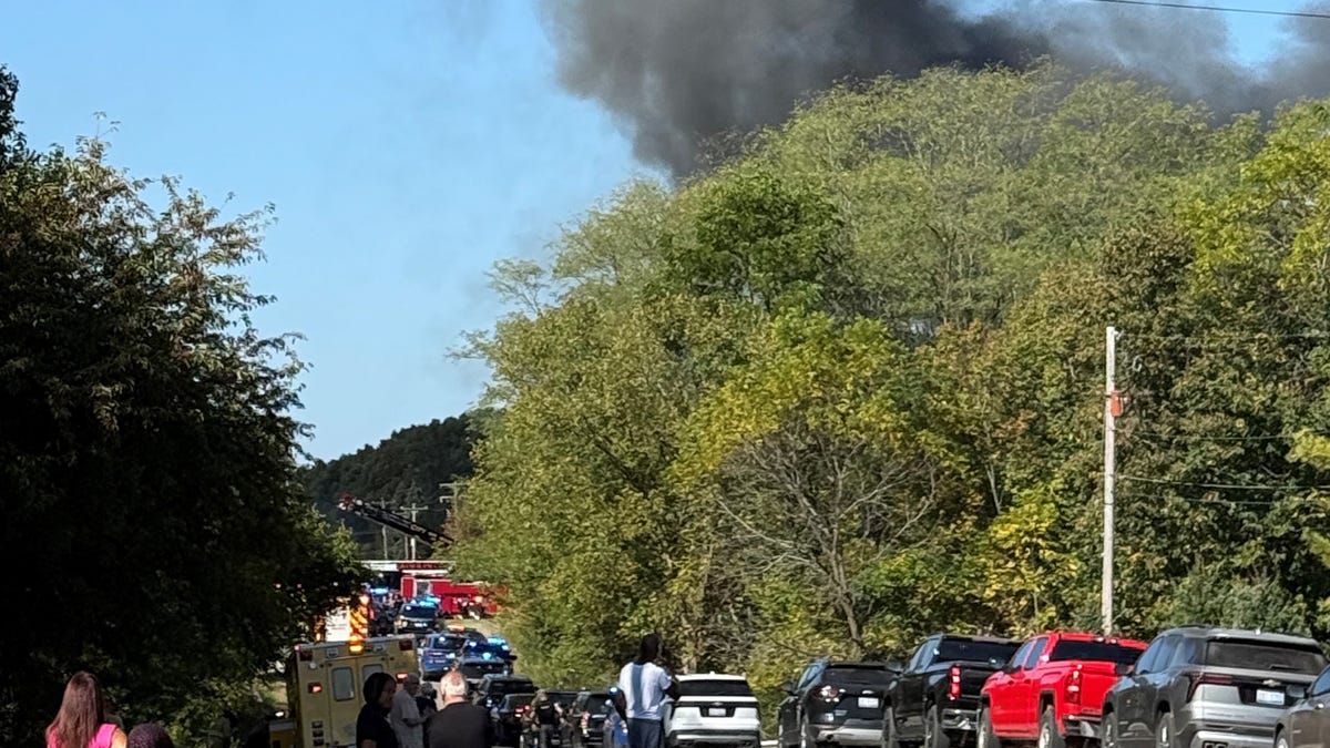 Smoke billows from The Church of Latter-Day Saints in Grand Blanc, Michigan, where police say a mass shooting took place on Sunday, Sept. 28, 2025.