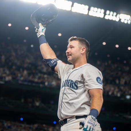 Cal Raleigh acknowledges the fans at T-Mobile Park after hitting his 60th home run.