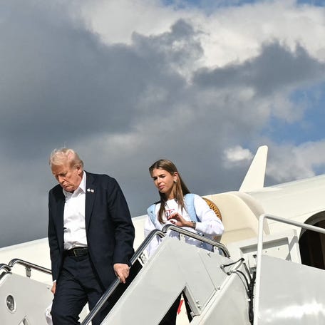 US President Donald Trump and his granddaughter Kai Trump step off Air Force One upon return to Joint Base Andrews in Maryland on September 26, 2025. Trump is returning to Washington, DC after attending the Ryder Cup in Farmingdale, New York.