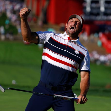 Team USA's Bryson DeChambeau reacts on the 18th hole on the final day of Ryder Cup competition.