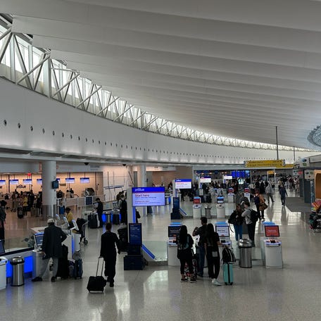Passengers check in at the JetBlue terminal at John F. Kennedy International Airport on May 7, 2025.
