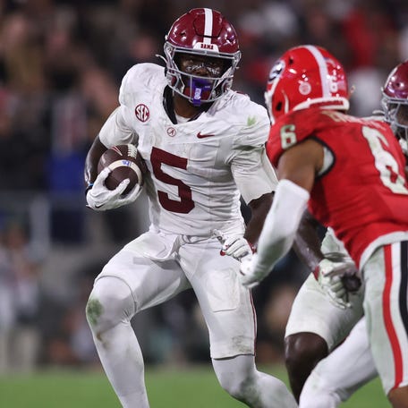 Alabama wide receiver Germie Bernard (5) tries to avoid the tackle of Georgia defensive back Daylen Everette (6) during their game at Sanford Stadium.