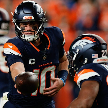Sep 29, 2025; Denver, Colorado, USA; Denver Broncos quarterback Bo Nix (10) hands the ball off to Denver Broncos running back J.K. Dobbins (27) during the second quarter against the Cincinnati Bengals at Empower Field at Mile High. Mandatory Credit: Isaiah J. Downing-Imagn Images