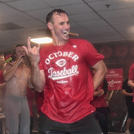Brent Suter celebrates in the clubhouse after Cincinnati clinched a playoff spot.