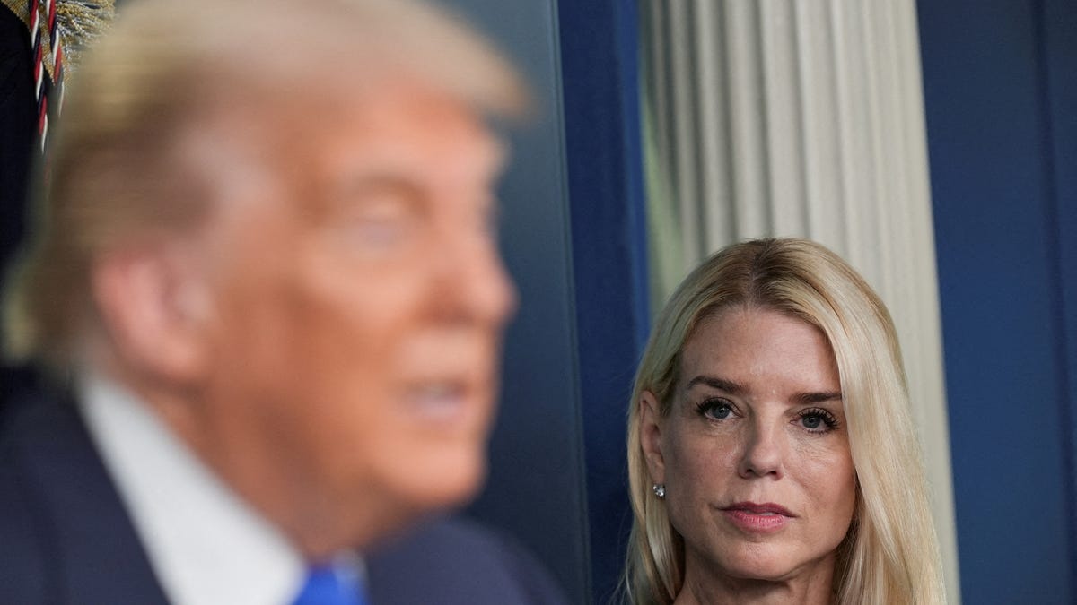 U.S. Attorney General Pam Bondi listens as U.S. President Donald Trump speaks to the media, after the U.S. Supreme Court dealt a blow to the power of federal judges by restricting their ability to grant broad legal relief in cases as the justices acted in a legal fight over President Donald Trump's bid to limit birthright citizenship, in the Press Briefing Room at the White House in Washington D.C., June 27, 2025.
