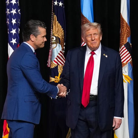 President Donald Trump greets Secretary of War Pete Hegseth as he arrives to speak to senior military leaders at Marine Corps Base Quantico in Northern Virginia on Sept. 30, 2025.