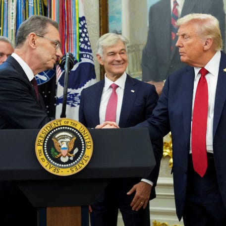 U.S. President Donald Trump shakes hands with Pfizer CEO Albert Bourla, on the day he announces a deal with Pfizer to sell drugs at lower prices, in the Oval office of the White House in Washington, D.C., U.S., September 30, 2025.
