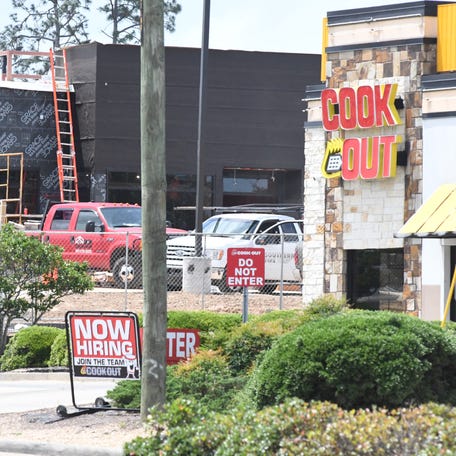 Restaurant signs along a narrow strip of Hardy Street in Hattiesburg, Miss., in May 2021.