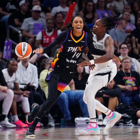 Aces guard Chelsea Gray (12) knocks away the ball from Mercury forward DeWanna Bonner (14).