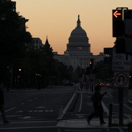 The sky begins to brighten just before sunrise behind the U.S. Capitol on the second day of a federal government shutdown in Washington, D.C., U.S., October 2, 2025.