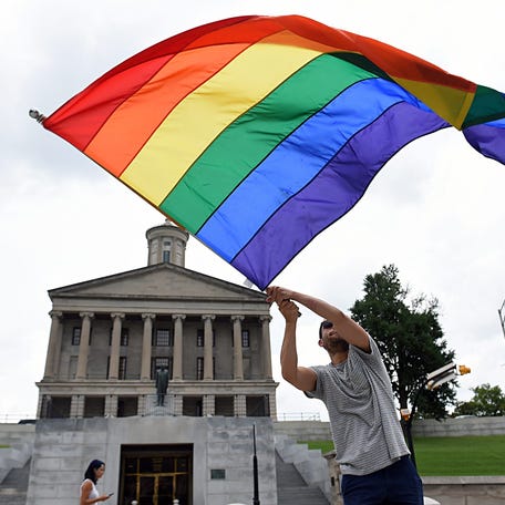 Christopher Shappley waves a gay pride flag during a celebration at the Tennessee state capital after the U.S. Supreme Court officially recognized the legal right for same-sex couples to be married on Friday, June 26, 2015.