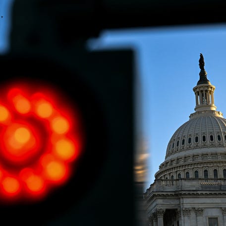 A signal at a parking lot displays a red light in front of the U.S. Capitol during the first day of a partial government shutdown in Washington, D.C. on Oct. 1, 2025.