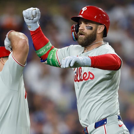 LOS ANGELES, CALIFORNIA - SEPTEMBER 15: Bryce Harper #3 of the Philadelphia Phillies celebrates a home run with J.T. Realmuto #10 against the Los Angeles Dodgers in the eighth inning at Dodger Stadium on September 15, 2025 in Los Angeles, California. (Photo by Ronald Martinez/Getty Images)