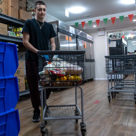 NEW YORK, NEW YORK - MARCH 25: Justin, a volunteer, fills a basket for a person in need of food at the Reaching Out Community Services food pantry on March 25, 2025, in the Brooklyn borough of New York City. This popular Brooklyn food pantry has been feeding thousands of New Yorkers each month while offering a host of other services to those in need. Like many food pantries nationwide, Reaching Out Community Services relies on food from City Harvest and other charitable groups that receive food   and funding from the USDA. The Donald Trump administration has proposed billions in cuts to funding for the USDA and other programs that assist those in need. (Photo by Spencer Platt/Getty Images)