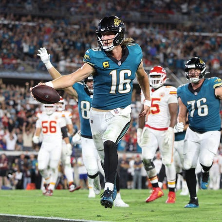 Oct 6, 2025; Jacksonville, Florida, USA; Jacksonville Jaguars quarterback Trevor Lawrence (16) scores a touchdown during the second half against the Kansas City Chiefs at EverBank Stadium.