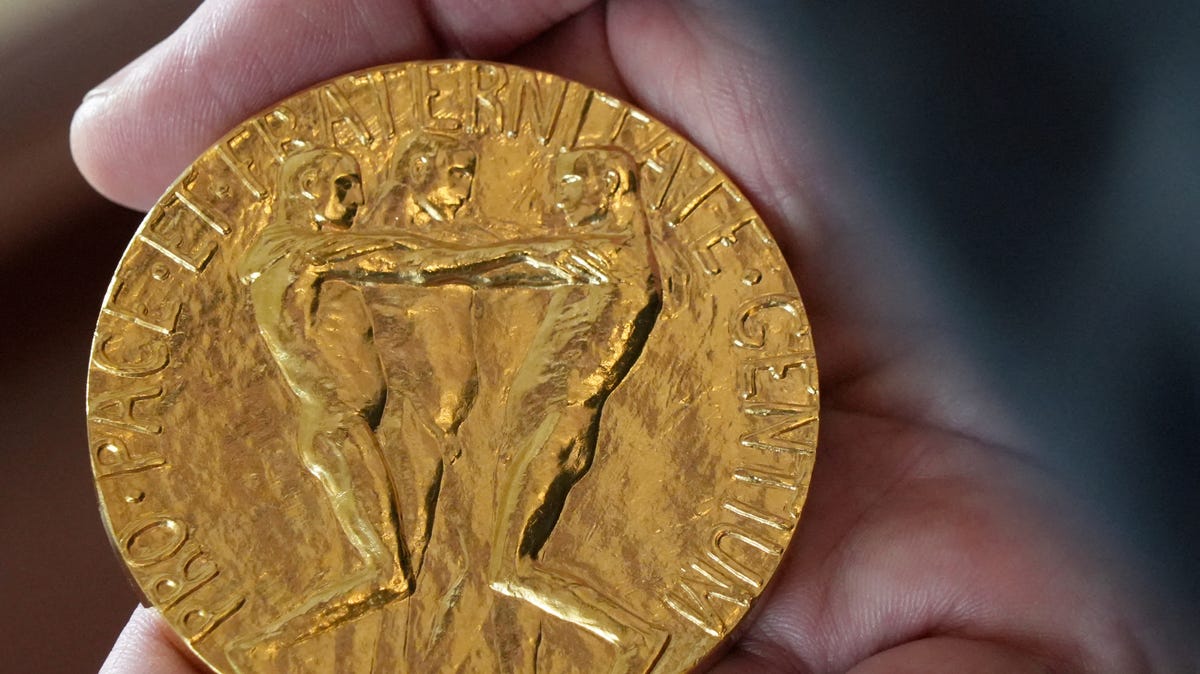 An employee of the Norwegian Nobel Institute holds a replica of a Nobel Peace Medal in the Institute in Oslo, Norway, on Sept. 9, 2025.