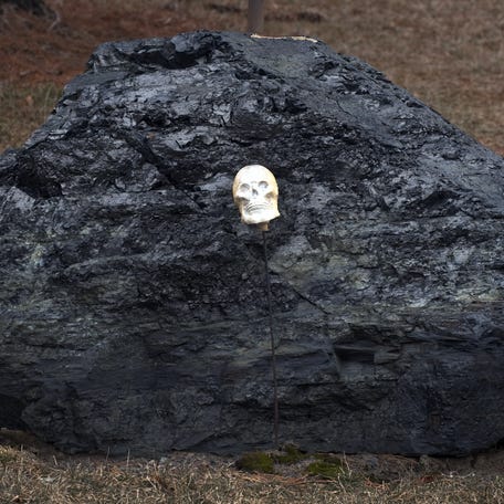 A boulder sized lump of coal has a miniature plastic human skull resting on it February 2, 2010 in Centralia, PA. The coal sits in the yard of a surviving house in the Pennsylvania town underwhich a subterranean coal fire has been burning for almost 50 years. The town with an original population of about 1,000 is now home to less than a dozen.