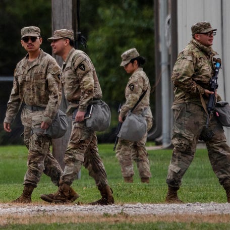 Texas National Guard troops walk through the Joliet Army Reserve Training Center in Elwood, Illinois, on Oct. 7, 2025.
