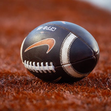 Dec 21, 2024; Austin, Texas, USA; Detailed view of a Nike logo on an official NCAA football during the Clemson Tigers game against the Texas Longhorns in the CFP National playoff first round at Darrell K Royal-Texas Memorial Stadium. Mandatory Credit: Mark J. Rebilas-Imagn Images