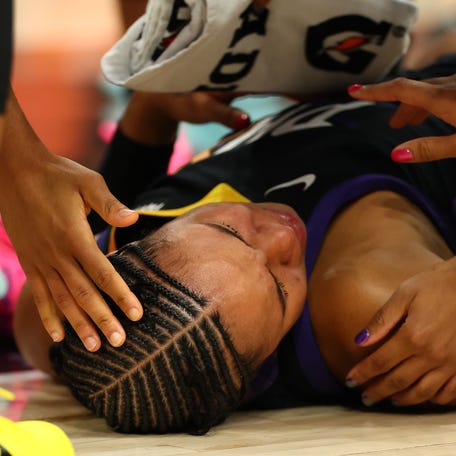Mercury forward Satou Sabally being examined after being injured in Game 3.