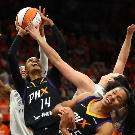 Mercury forward DeWanna Bonner (14) shoots the ball over Las Vegas Aces center A'ja Wilson (22).