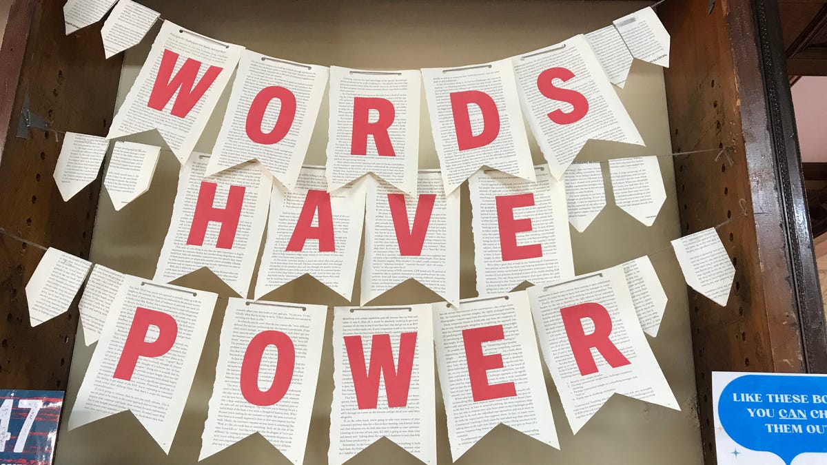 A handcrafted sign "Words Have Power" is seen over a display of banned books at the Hoboken Public Library in New Jersey on March 29, 2024.