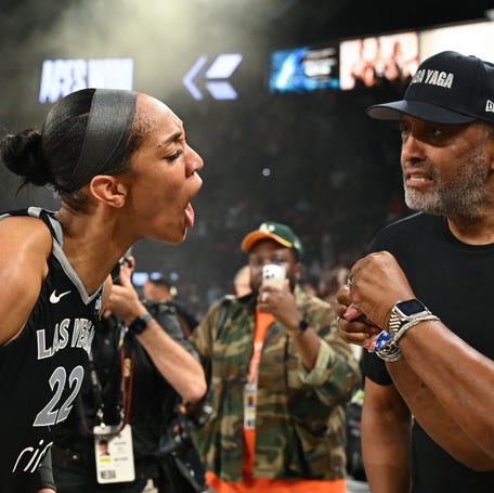 Aces center A'ja Wilson (22) celebrates defeating the Seattle Storm with her parents Roscoe and Eva Wilson in semifinals of 2025 WNBA playoffs.
