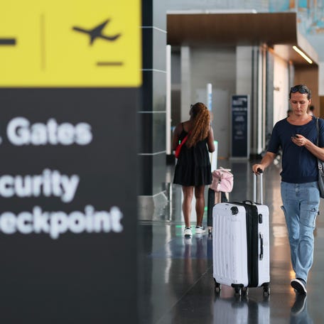 People walk through Terminal 7 at JFK Airport on August 29, 2025 in New York, New York.