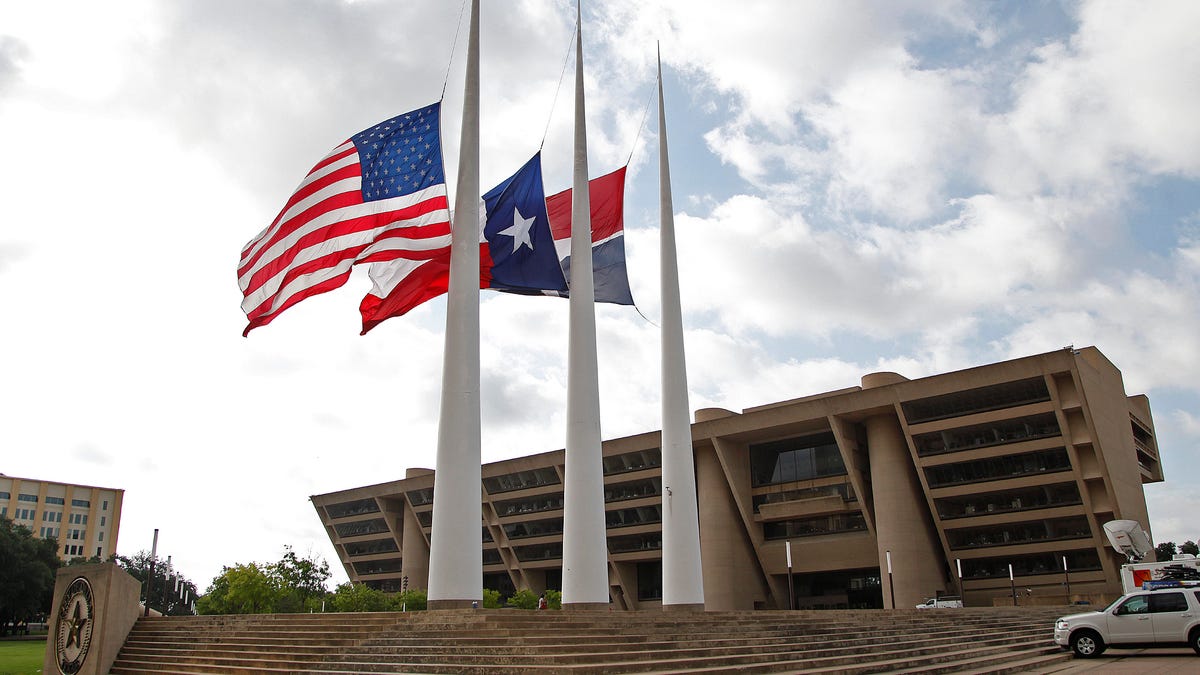 DALLAS, TX: Flags at Dallas City Hall fly at half mast after the fatal shootings of five police officers on July 8, 2016, in Dallas, Texas, following a downtown demonstration. The shooter, identified as former Army reservist Micah Johnson, was killed by a police robot armed with a bomb.