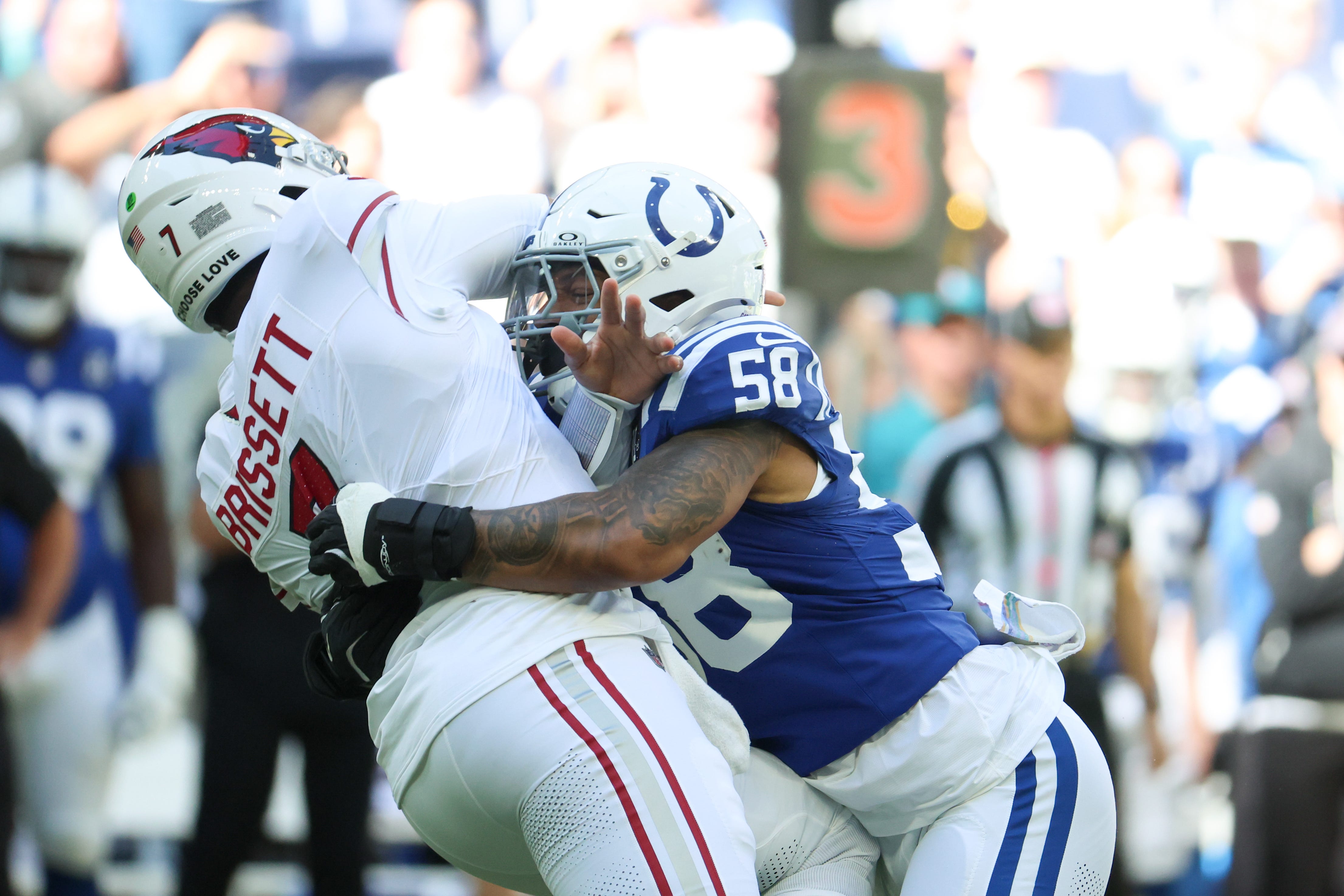Oct 12, 2025; Indianapolis, Indiana, USA; Indianapolis Colts linebacker Austin Ajiake (58) puts pressure on Arizona Cardinals quarterback Jacoby Brissett (7) during the first quarter of the game at Lucas Oil Stadium. Mandatory Credit: Trevor Ruszkowski-Imagn Images
