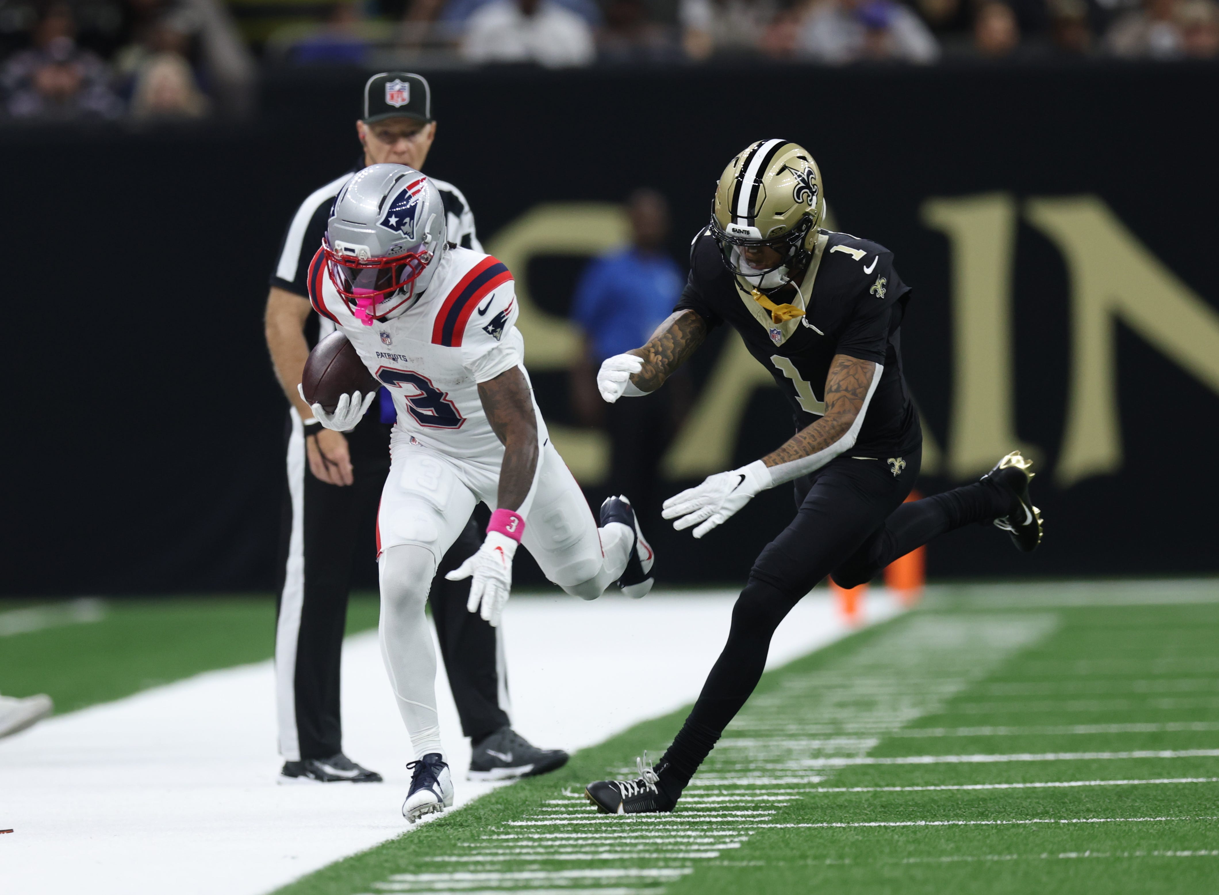 Oct 12, 2025; New Orleans, Louisiana, USA; New England Patriots wide receiver Demario Douglas (3) is pushed out of bounds by New Orleans Saints cornerback Alontae Taylor (1) during the second quarter at Caesars Superdome. Mandatory Credit: Stephen Lew-Imagn Images