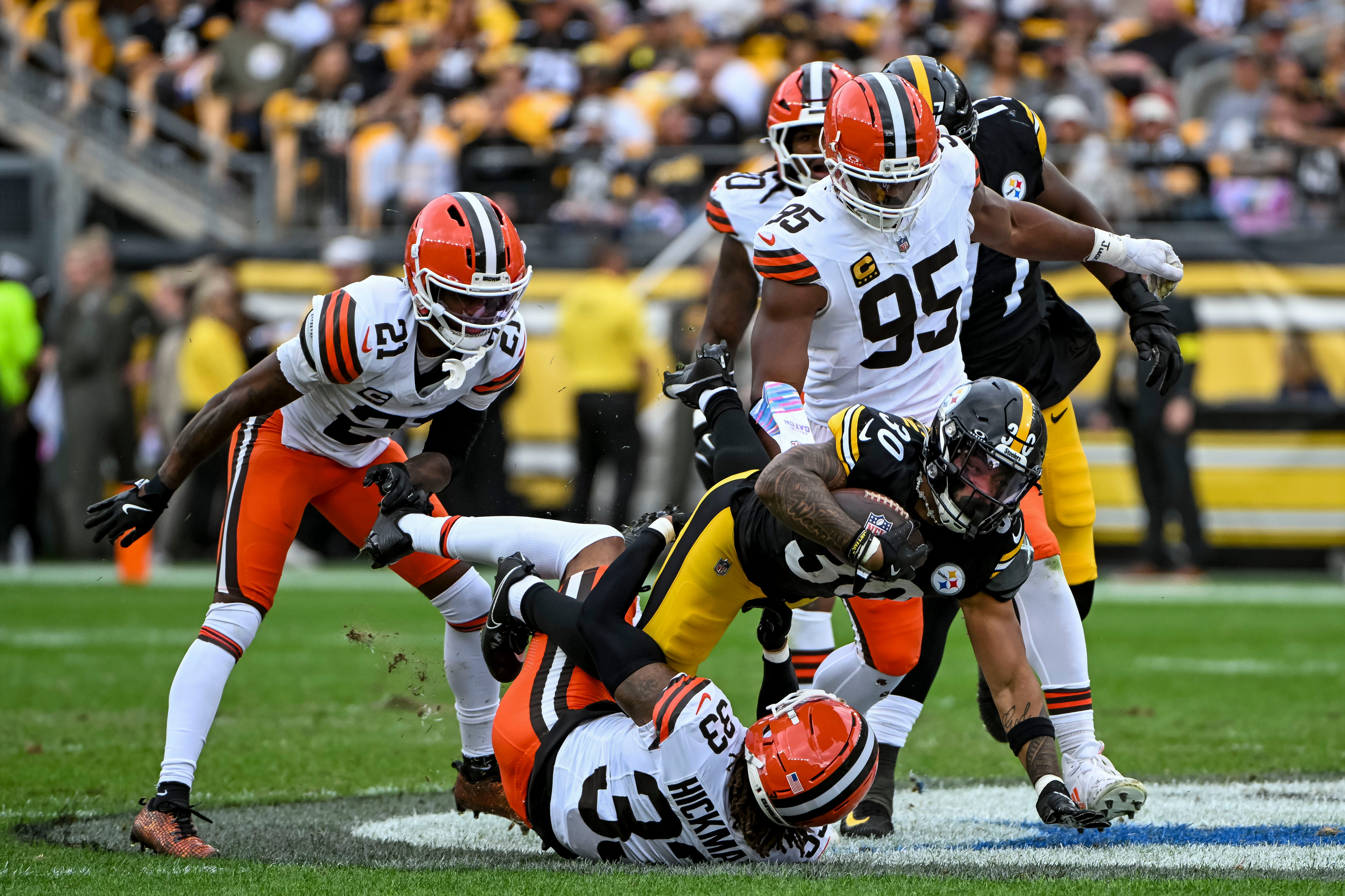 Oct 12, 2025; Pittsburgh, Pennsylvania, USA; Pittsburgh Steelers running back Jaylen Warren (30) is tackled by Cleveland Browns defense during the second quarter at Acrisure Stadium. Mandatory Credit: Barry Reeger-Imagn Images
