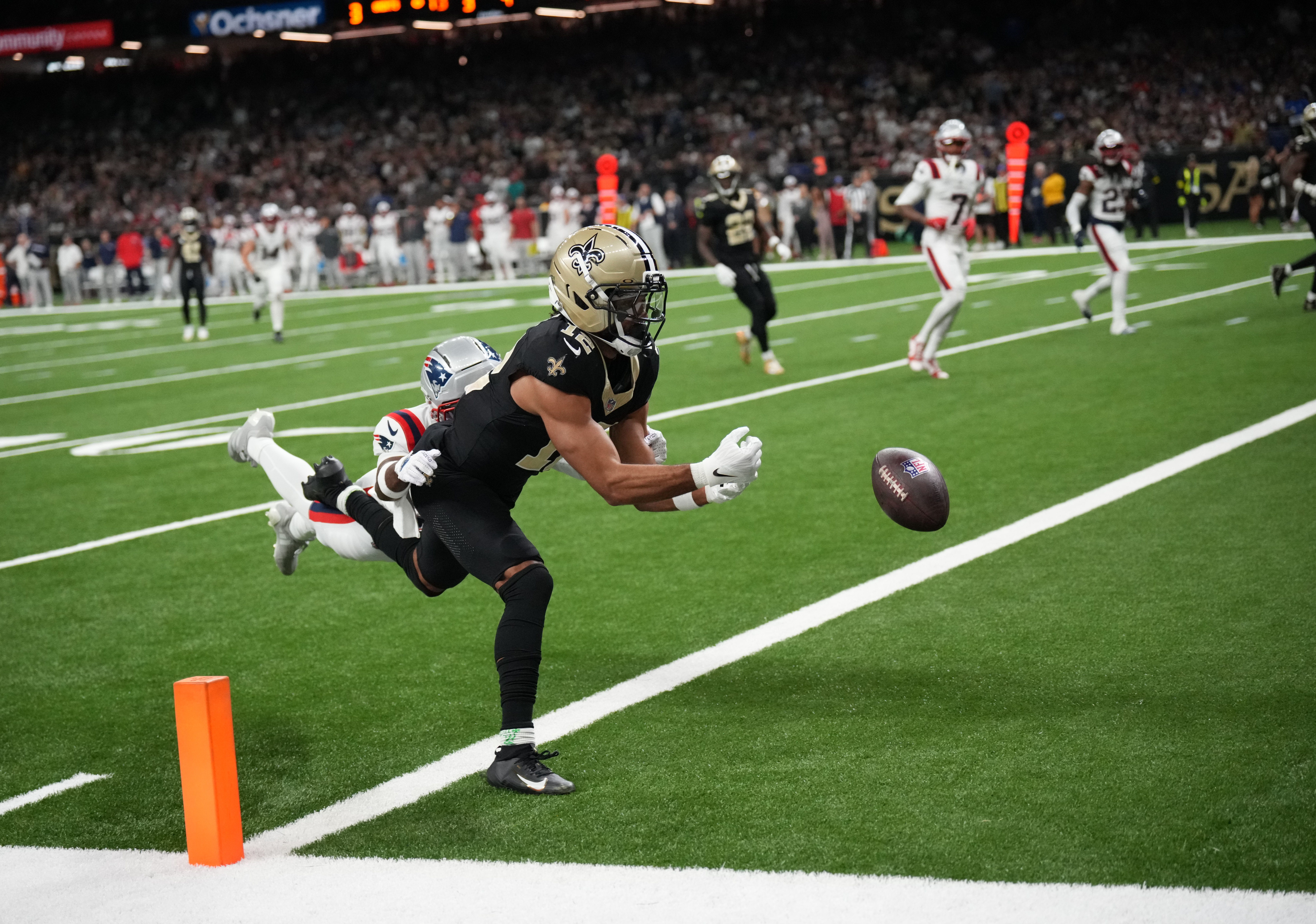 Oct 12, 2025; New Orleans, Louisiana, USA; New Orleans Saints wide receiver Chris Olave (12) misses a touchdown pass under pressure from New England Patriots cornerback Marcus Jones (25) during the second quarter at Caesars Superdome. Mandatory Credit: Matthew Hinton-Imagn Images