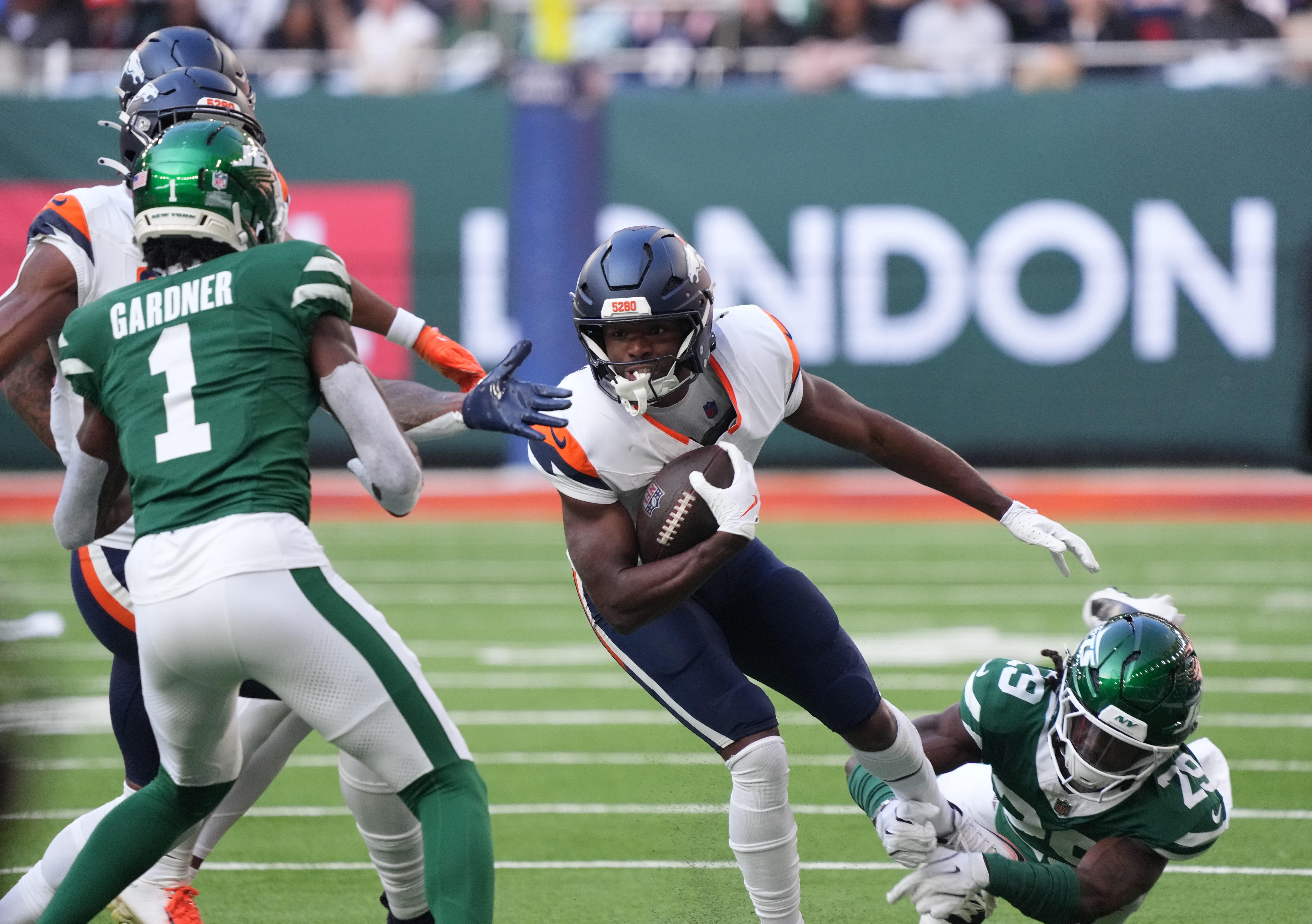 Oct 12, 2025; Tottenham, United Kingdom; Denver Broncos wide receiver Marvin Mims Jr. (19) runs with the ball against the New York Jets during an NFL International Series game at Tottenham Hotspur Stadium. Mandatory Credit: Kirby Lee-Imagn Images