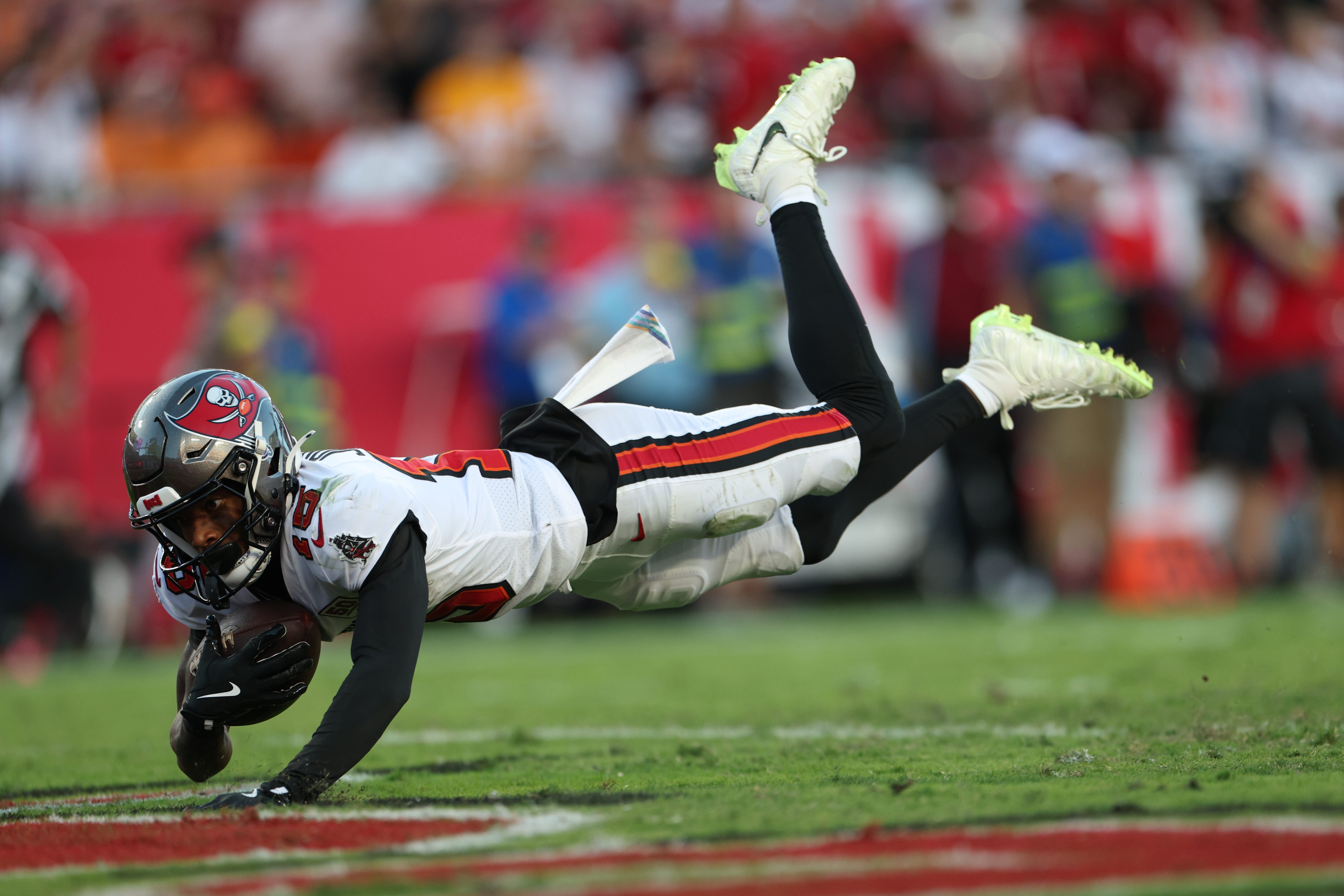Oct 12, 2025; Tampa, Florida, USA; Tampa Bay Buccaneers wide receiver Tez Johnson (15) dives for a touchdown during the third quarter against the San Francisco 49ers at Raymond James Stadium. Mandatory Credit: Nathan Ray Seebeck-Imagn Images