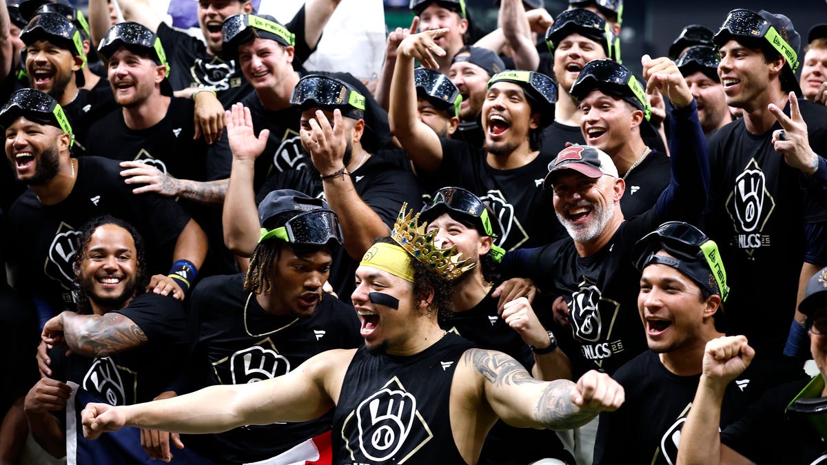The Milwaukee Brewers pose for a photo after their 3-1 win against the Chicago Cubs in Game 5 of the NLDS.