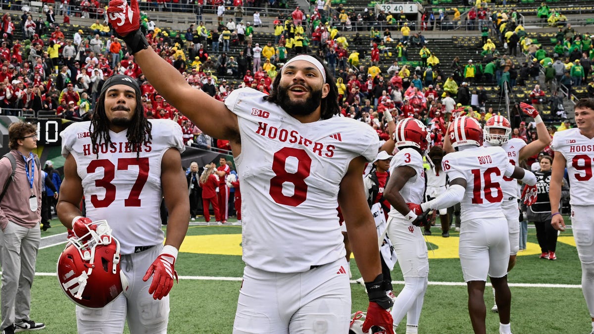 Indiana defensive lineman Stephen Daley (8), tight end Riley Nowakowski (37) and offenive lineman Carter Smith (65) celebrate on the field after the team's defeat of Oregon at Autzen Stadium.