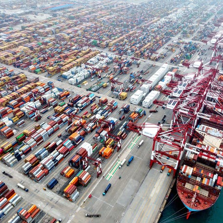 Ships are berthed at the container terminal of the port in Qingdao, in China's eastern Shandong province on October 11, 2025. China accused the United States of "double standards" on October 12, after President Donald Trump threatened an additional 100 percent tariff on the world's second-largest economy.