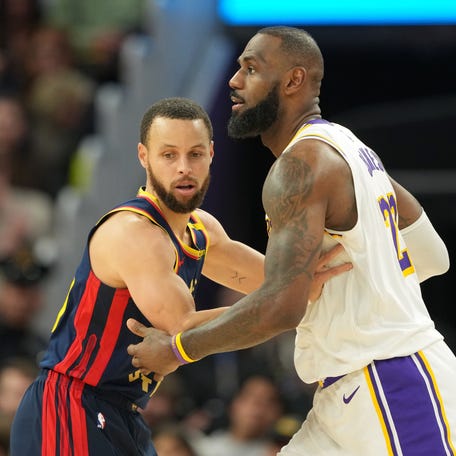 Golden State Warriors guard Stephen Curry (left) defends against Los Angeles Lakers forward LeBron James (right) during the fourth quarter at Chase Center in San Francisco, California, on Jan. 25, 2025.