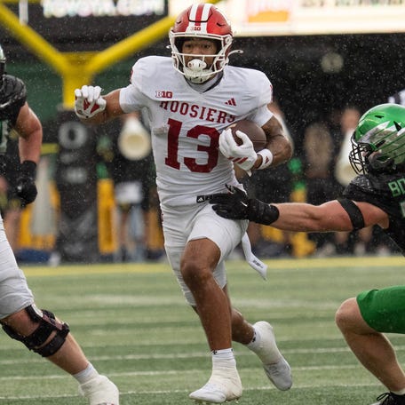 Indiana wide receiver Elijah Sarratt carries the ball during his team's game against Oregon at Autzen Stadium.
