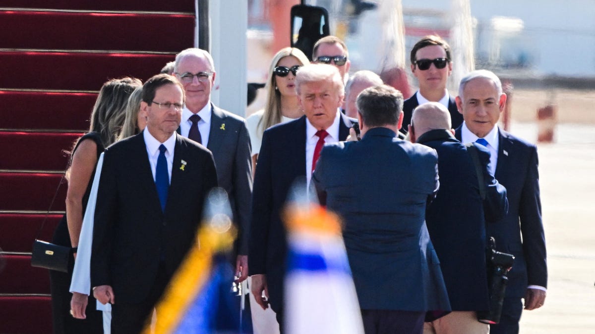 U.S. President Donald Trump walks with Israeli President Isaac Herzog, Israeli Prime Minister Benjamin Netanyahu and others at Ben Gurion International airport, on the day Israeli hostages are released by Hamas and Palestinian prisoners by Israel after a ceasefire went into effect under the first phase of a U.S.-brokered agreement, in Lod, Israel October 13, 2025.