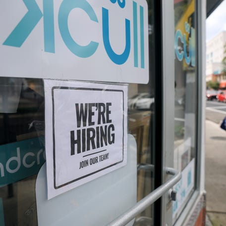 A 'We're Hiring' sign is taped to the window of a business on October 03, 2025 in Miami, Florida. Due to the U.S. Government shutdown the Bureau of Labor Statistics will not be releasing September's employment data. (Photo by Joe Raedle/Getty Images)