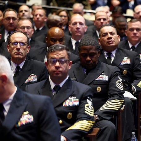 Members of the military wait for President Donald Trump to arrive for a meeting convened by Defense Secretary Pete Hegseth, at Marine Corps Base Quantico, in Quantico, Virginia, on Sept. 30, 2025.