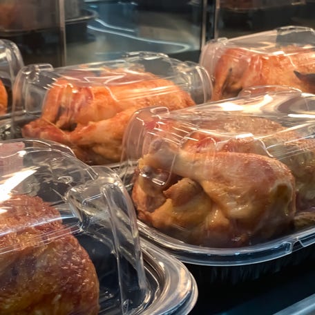 Packed roast chicken on the shelf waiting to be sold in the market deli section.